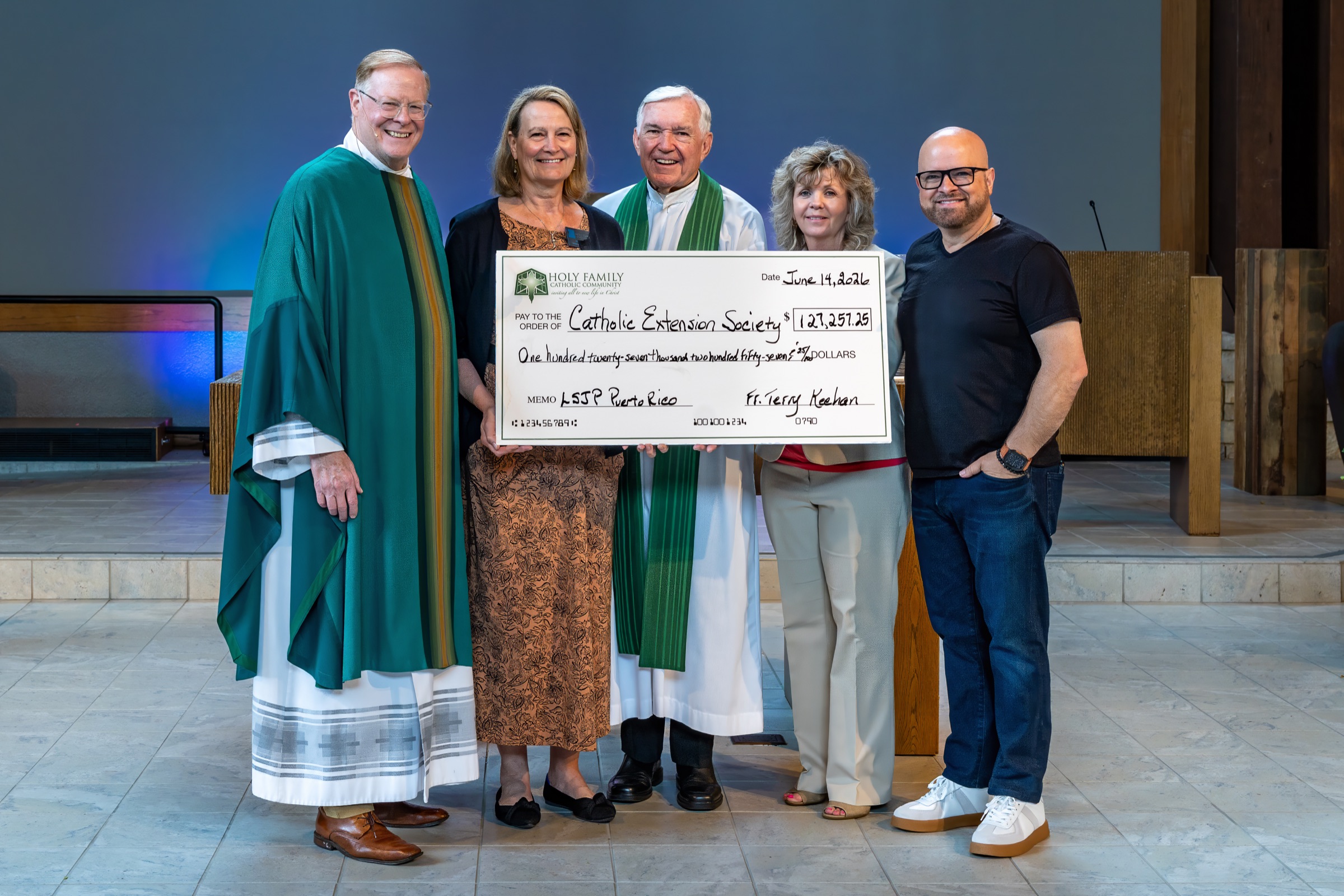 Holy Family presenting a donation check to Catholic Extension Society for Puerto Rico